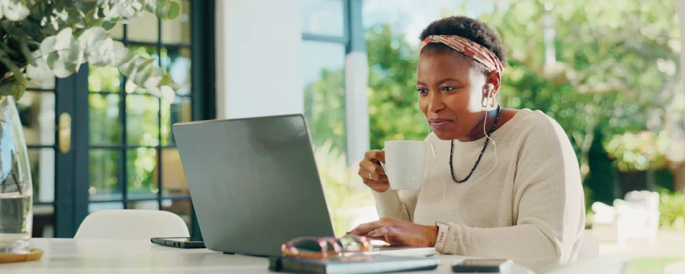 Female African American educator sitting outdoors using a laptop to engage in free
professional development for teachers.